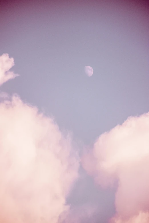 a plane flying through a cloudy blue sky, a picture, inspired by Elsa Bleda, unsplash, aestheticism, giant pink full moon, pastel purple background, 15081959 21121991 01012000 4k, dreamy kodak color stock