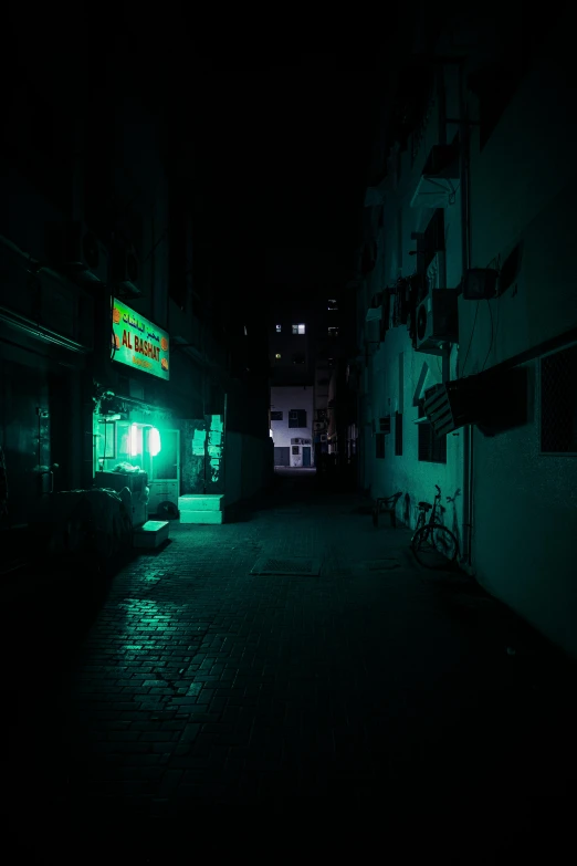 a dark street at night with a green light, an album cover, inspired by Elsa Bleda, old jeddah city alley, cinematic shot ar 9:16 -n 6 -g, dark photo, night clubs and neons