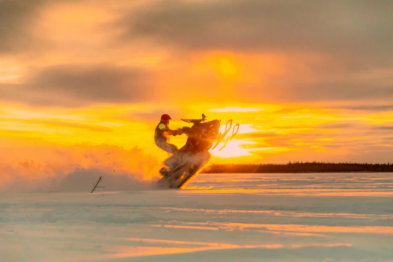 a man riding skis down the side of a snow covered slope, by Veikko Törmänen, pexels contest winner, hurufiyya, in a golden sunset sky, electric cats that fly over ice, white, motorsports photography