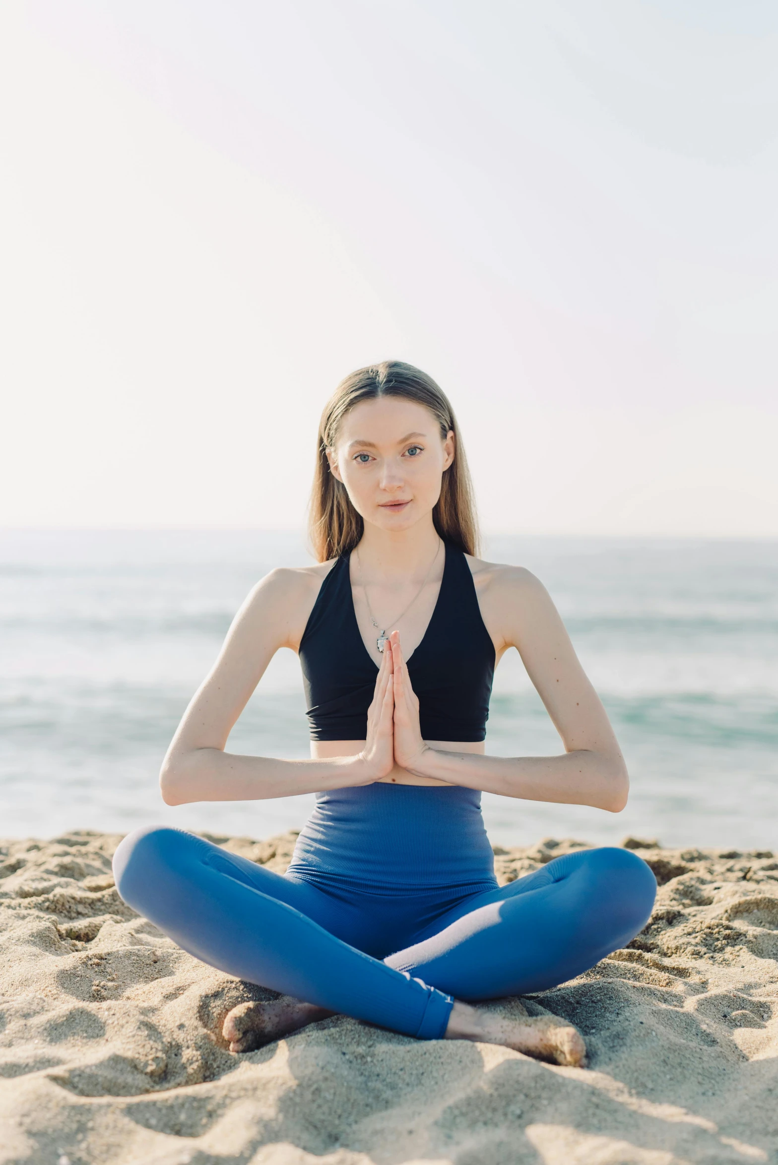 a woman is doing yoga on the beach, an album cover, unsplash, portrait sophie mudd, sitting with wrists together, sydney sweeney, transparent