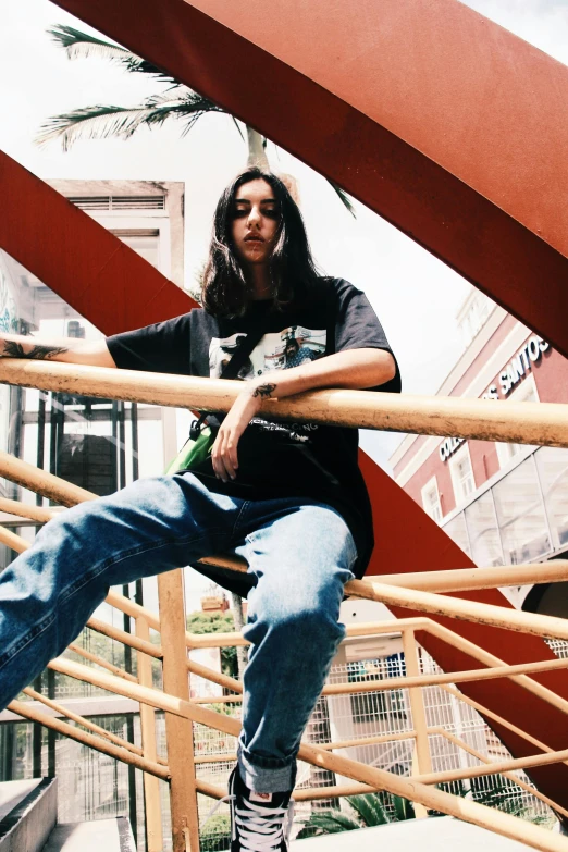 a man sitting on a railing on a skateboard, an album cover, by Pablo Rey, trending on unsplash, female with long black hair, jeans and t shirt, looking threatening, construction