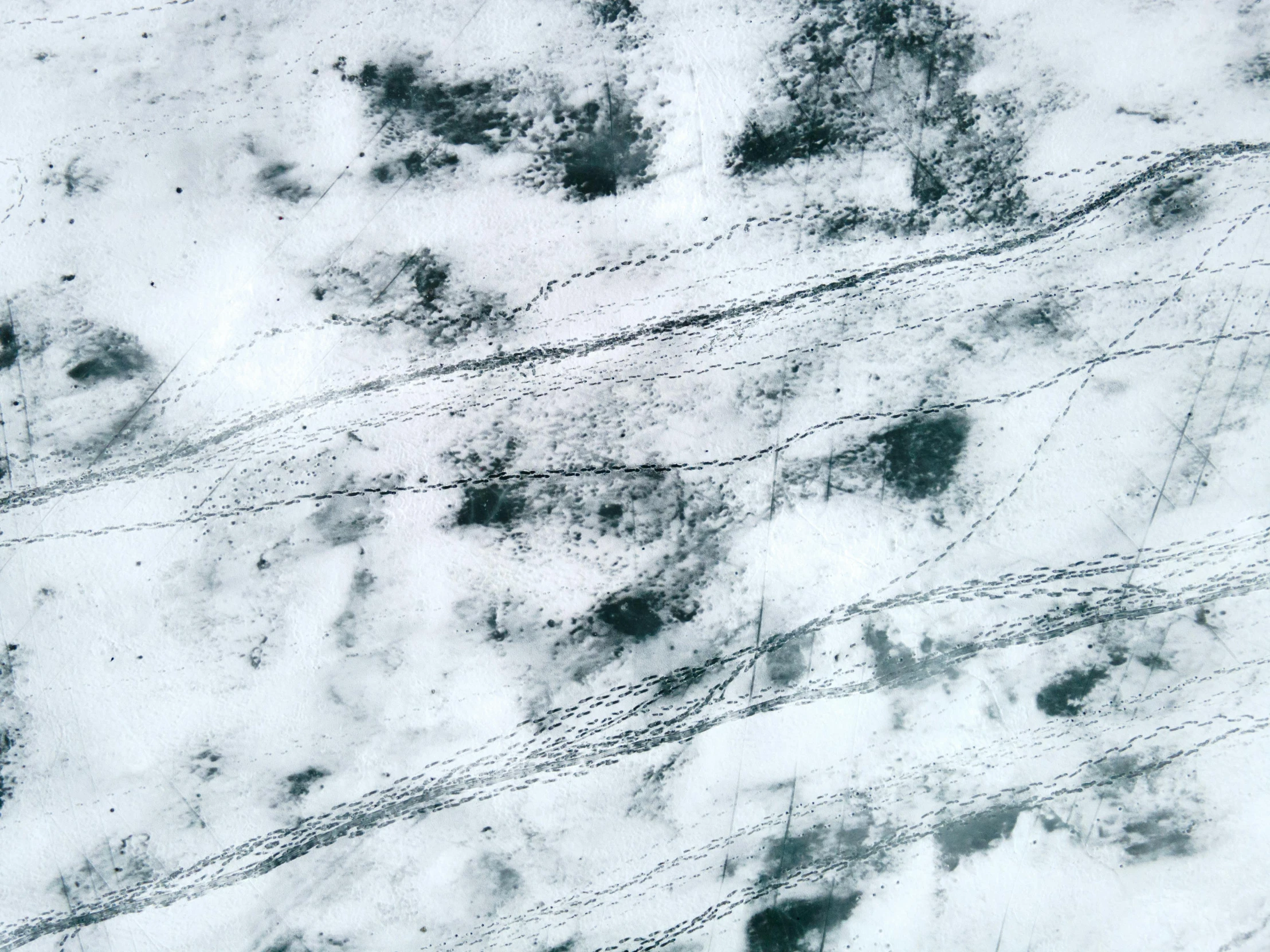 a man riding a snowboard down a snow covered slope, an abstract drawing, inspired by Vija Celmins, trending on pexels, lyrical abstraction, high resolution coal texture, aerial view. hand stitching, marble, fog on ground