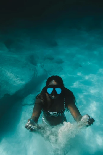 a woman in a bikini and goggles swimming in the ocean, pexels contest winner, graffiti, go pro footage, dark skinned, head straight down, shades