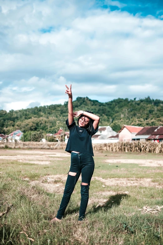 a woman throwing a frisbee in a field, an album cover, pexels contest winner, happening, indonesia, doing a sassy pose, black, pose(arms up + happy)