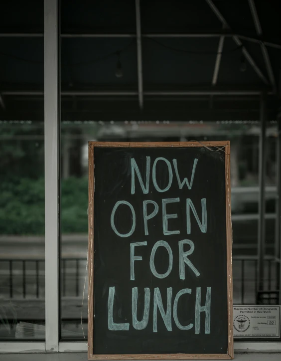 a sign that says now open for lunch, a photo, trending on unsplash, happening, thumbnail, low quality photo, portrait photo, grainy photo