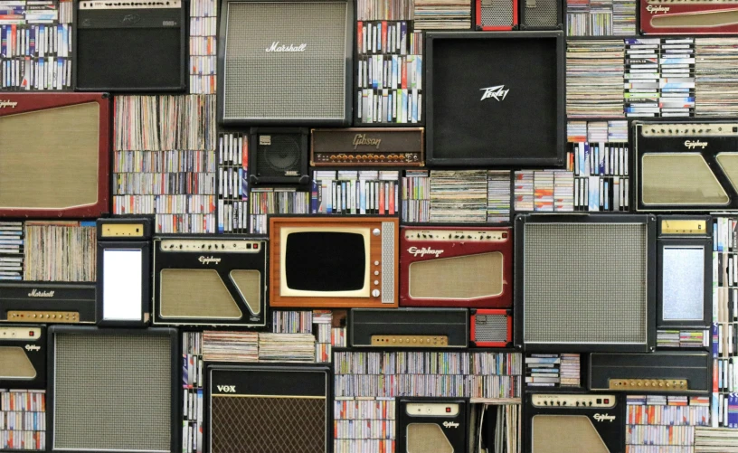 a bunch of guitars and amps stacked on top of each other, inspired by Wolf Vostell, trending on pexels, maximalism, an old tv, library of babel, tv screens, cassette