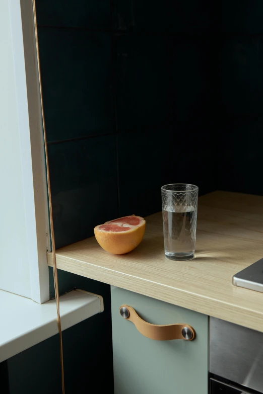 a laptop computer sitting on top of a wooden desk, a picture, by Harvey Quaytman, renaissance, kitchen counter, dwell, lemon, transparent