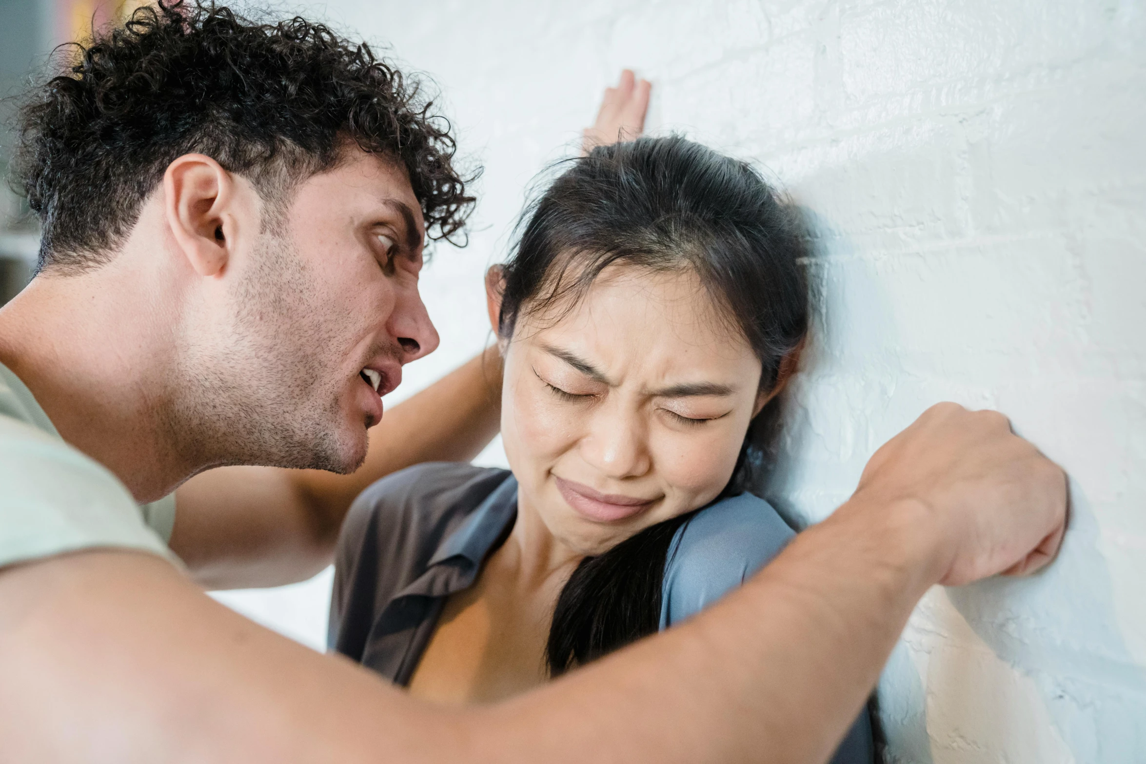 a man and a woman leaning against a wall, trending on pexels, violently fist fighting, woman crying, manuka, facing each other