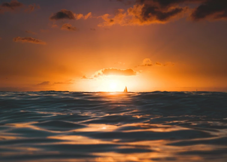 a sailboat in the ocean at sunset, a picture, by Daniel Lieske, pexels contest winner, breathtaking wave, hawaii beach, orange sun set, waist high