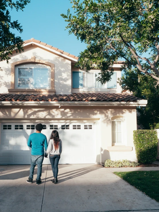 a man and a woman standing in front of a house, by Carey Morris, unsplash, driveway, inspect in inventory image, hispanic, promo image