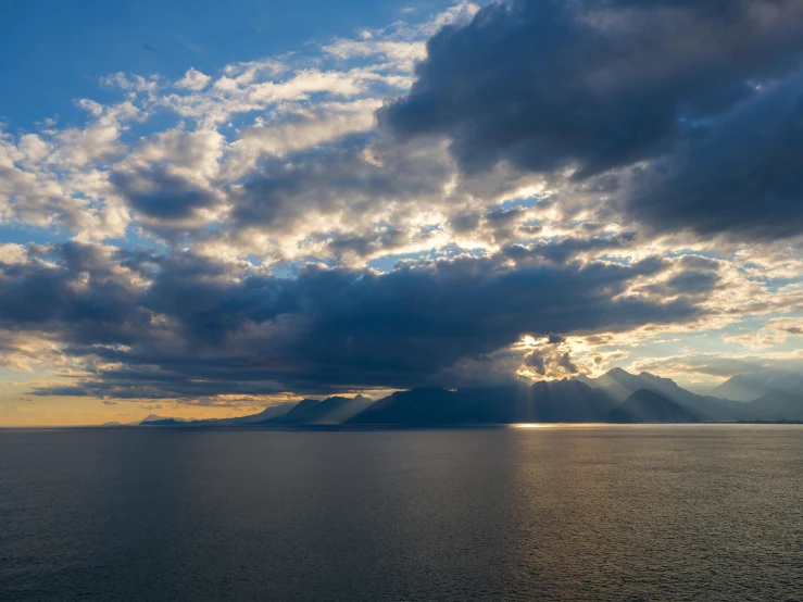 a large body of water under a cloudy sky, by Alessandro Allori, pexels contest winner, romanticism, sun lit, skye meaker, light and dark, mediterranean vista