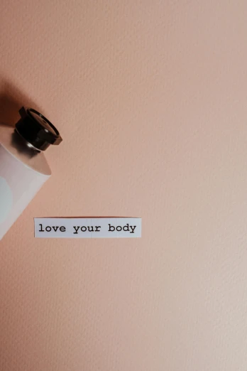 a piece of paper with the words love your body on it, trending on pexels, bottle, wallpaper aesthetic, humanoid body, body complet