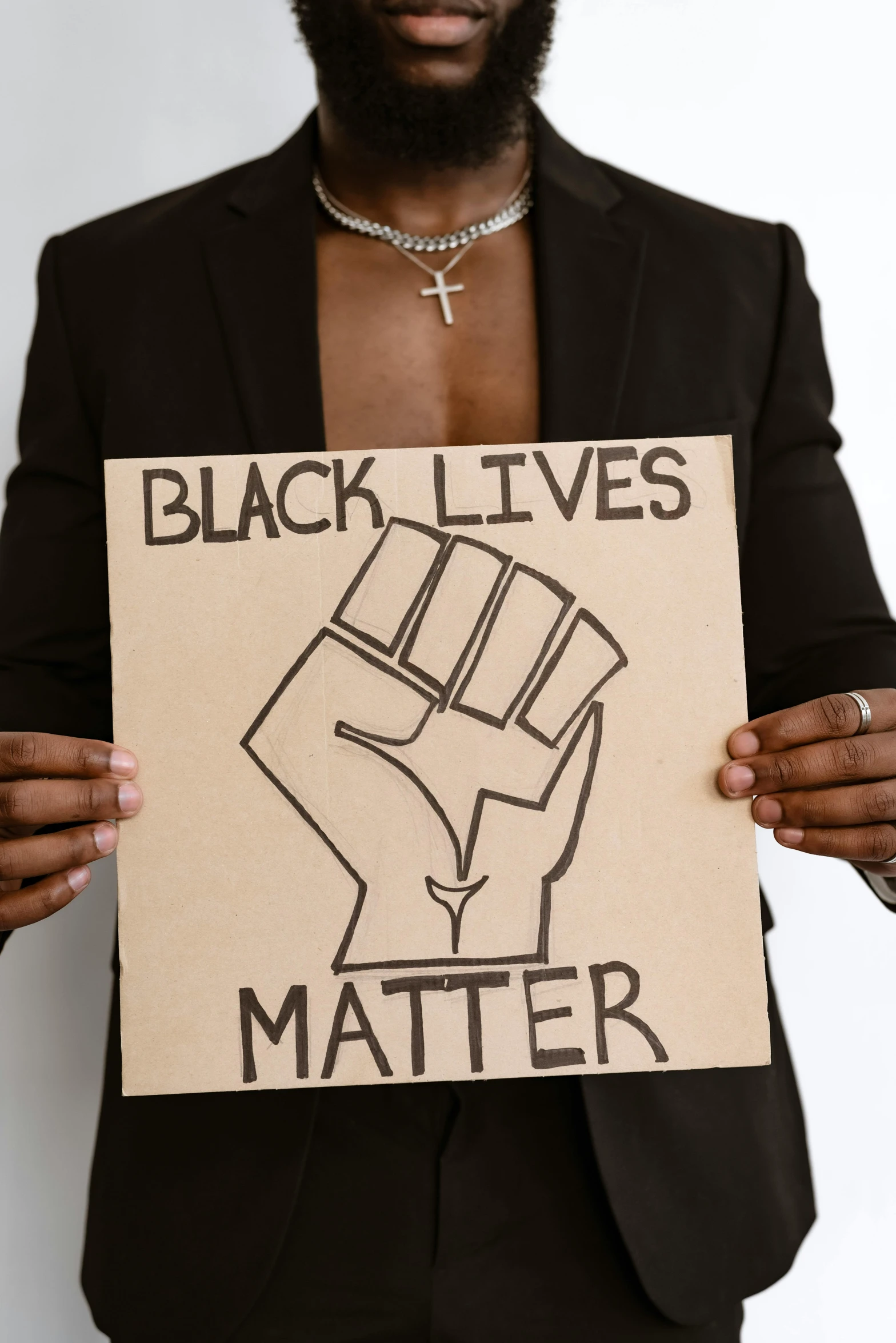 a man holding a sign that says black lives matter, an album cover, by Nina Hamnett, trending on pexels, etsy, b