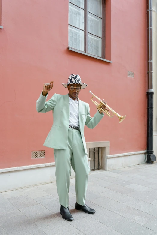 a man in a suit and hat playing a trumpet, by Ottó Baditz, pexels contest winner, dada, in style of juergen teller, sea - green and white clothes, adut akech, on the street