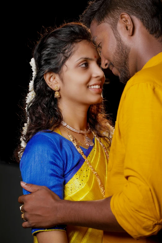 a man and a woman standing next to each other, a picture, by Max Dauthendey, hurufiyya, close up dslr studio photograph, yellow and blue, vmk myvmk, romantic couple