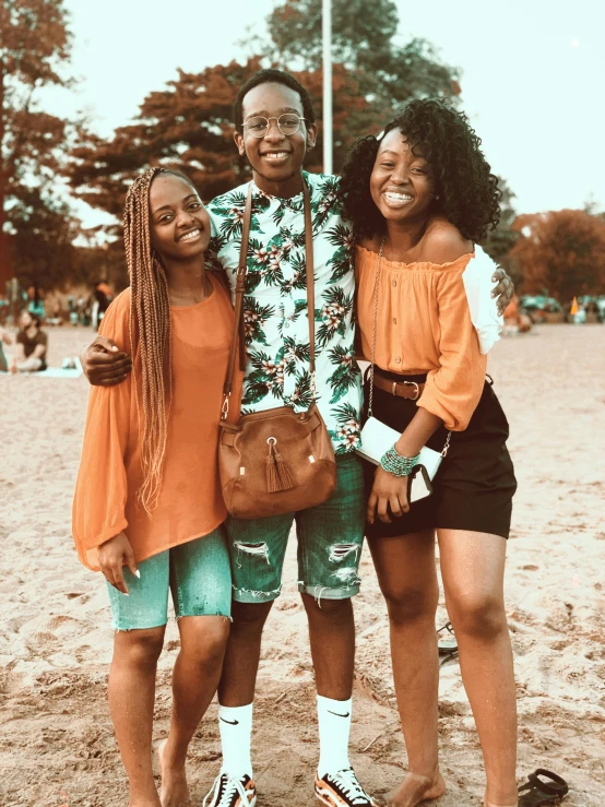 a group of people standing next to each other on a beach, brown skinned, older sister vibes, orange and teal color, college