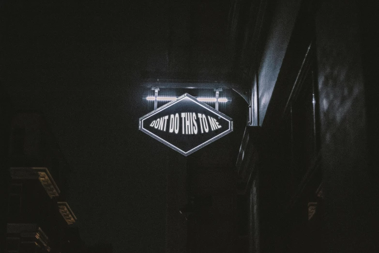 a neon sign hanging from the side of a building, trending on unsplash, dark theme night time, don't trip, to me, dan dos santos