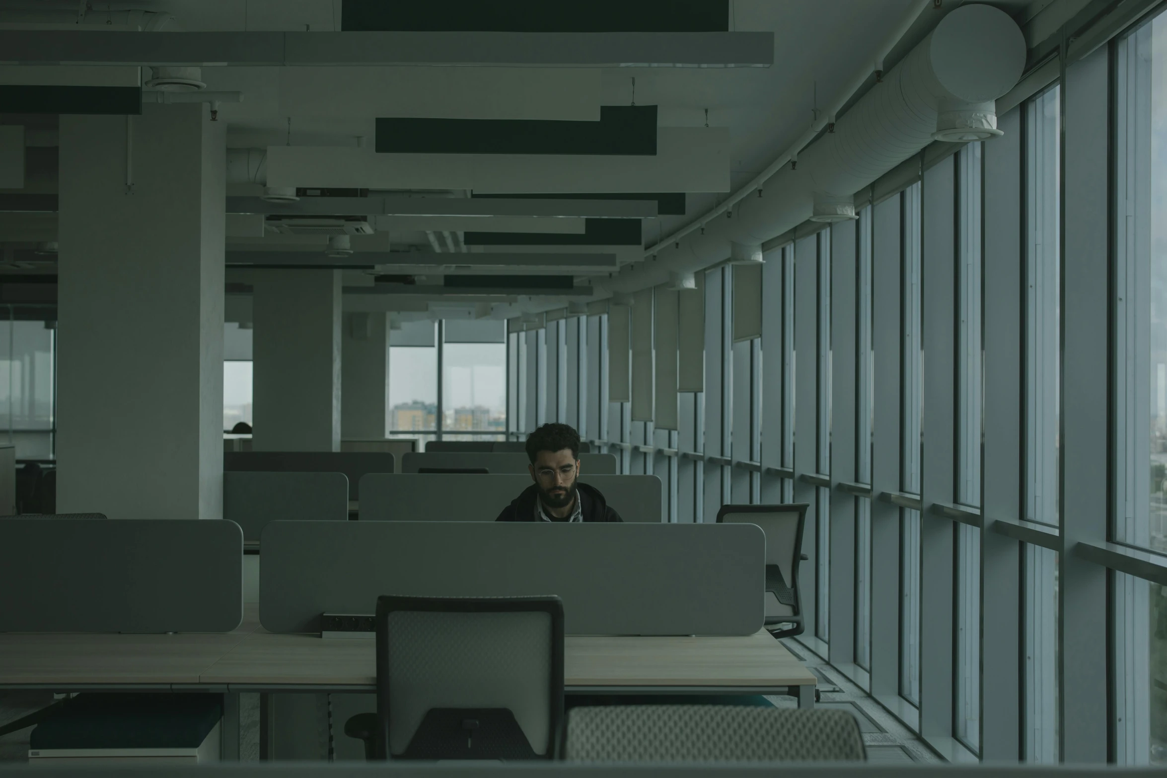 a man sitting at a desk in an office, inspired by Elsa Bleda, unsplash contest winner, serial art, 2 0 2 1 cinematic 4 k framegrab, endless empty office building, movie still 8 k, in an call centre office