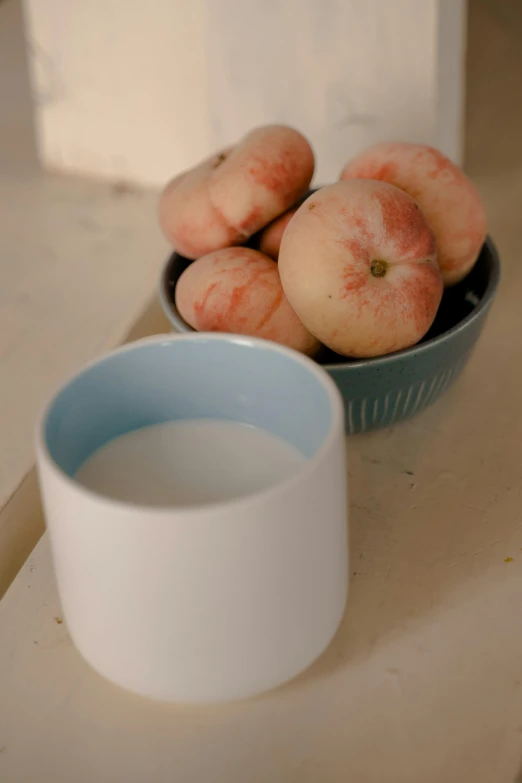 a bowl of doughnuts next to a bowl of milk, inspired by Giorgio Morandi, dada, peaches, soft blue light, 2 5 6 x 2 5 6 pixels, beakers