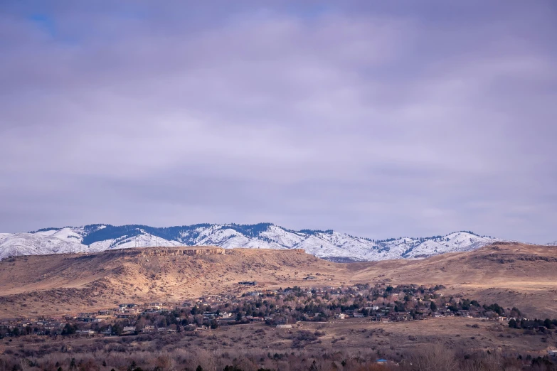 the mountains are covered in snow on a cloudy day, a portrait, unsplash, distant town in valley and hills, idaho, background image, full res