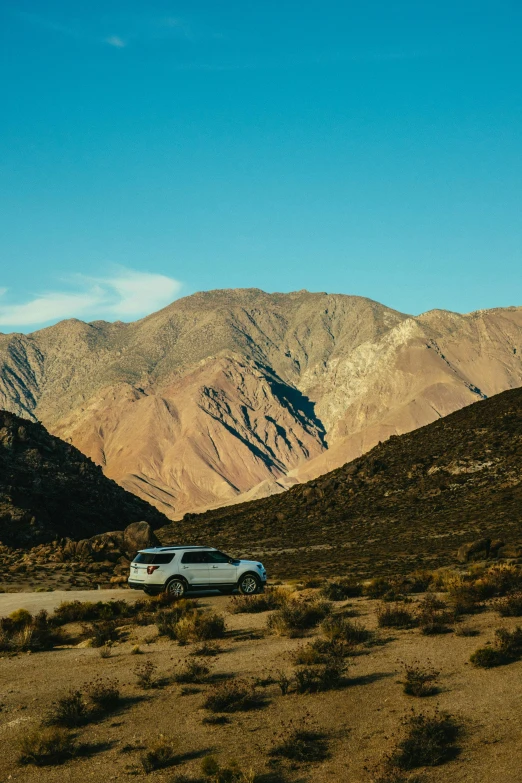 a van parked in the middle of a desert with mountains in the background, andes mountain forest, 4k image”, multiple stories, malibu canyon