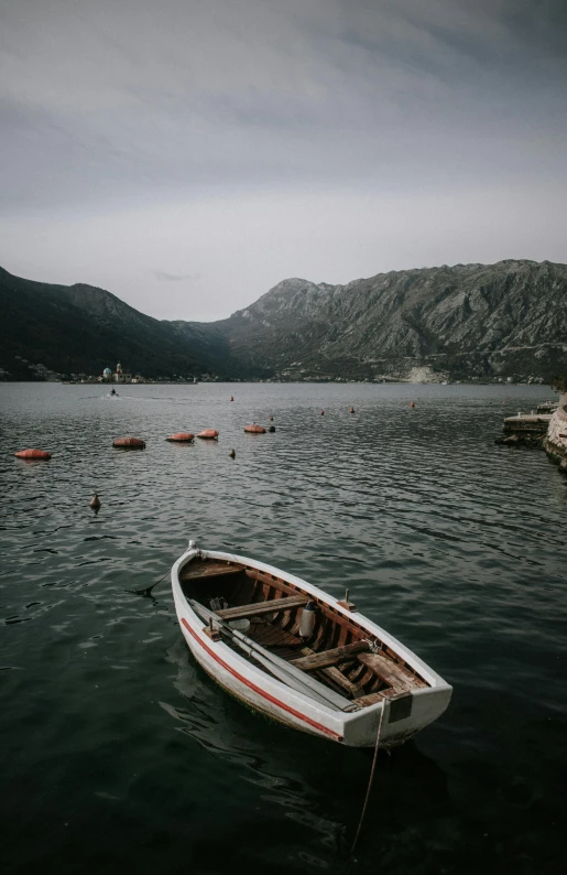 a small boat sitting on top of a body of water, by Sebastian Spreng, unsplash contest winner, boka, small port village, low quality photo, tourist photo