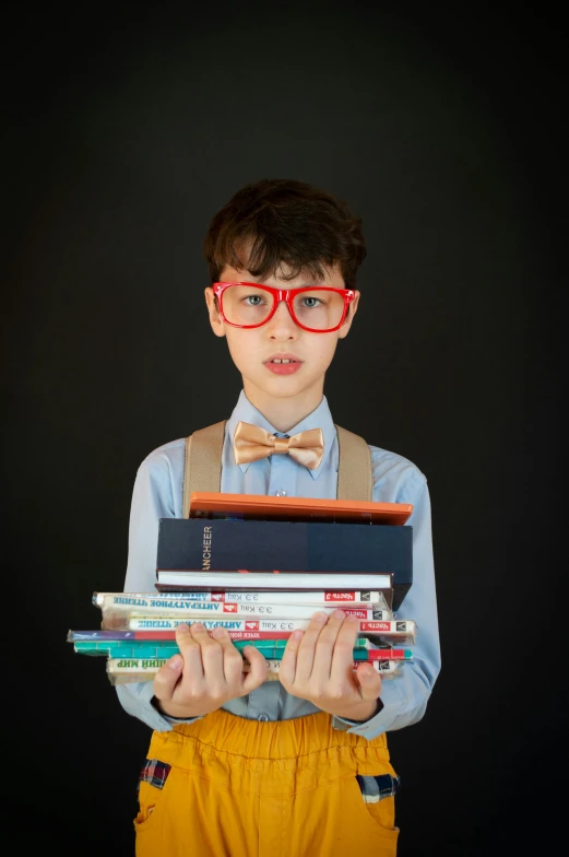 a boy with glasses holding a stack of books, by Alison Geissler, slide show, jaime jasso, portrait n - 9, small