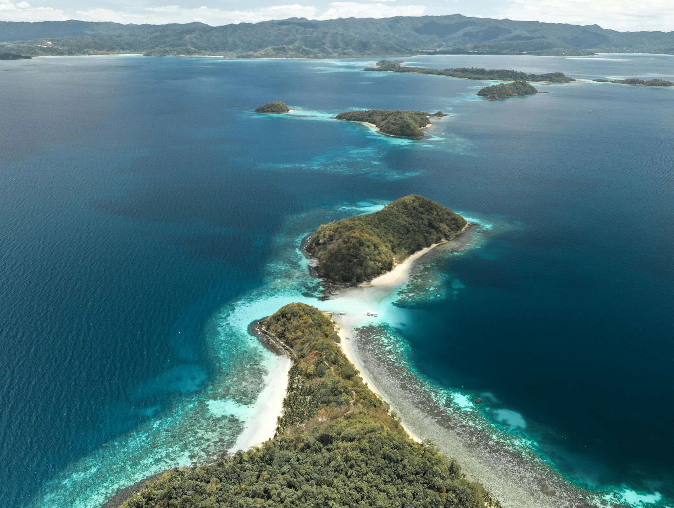 an aerial view of an island in the middle of the ocean, by Joseph Severn, pexels contest winner, sumatraism, thumbnail, two medium sized islands, conde nast traveler photo, subtitles