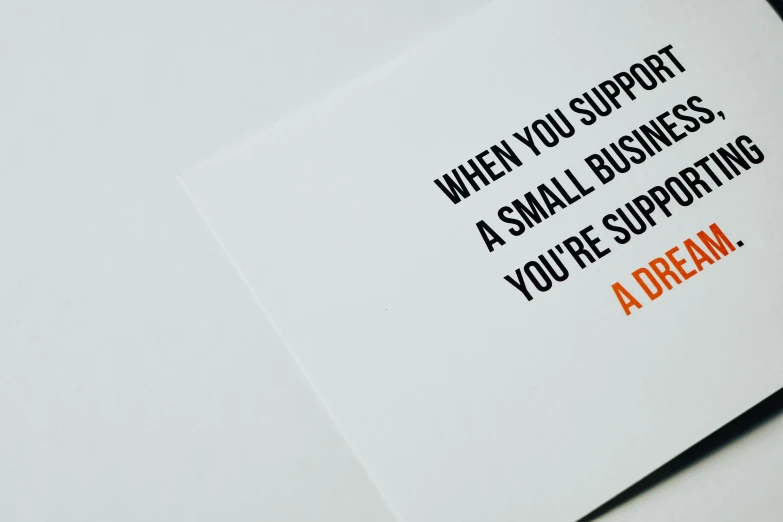 a card that says when you support a small business, you're supporting a dream, a picture, unsplash, private press, low - angle shot from behind, abundent in details, an orange, awkward situation