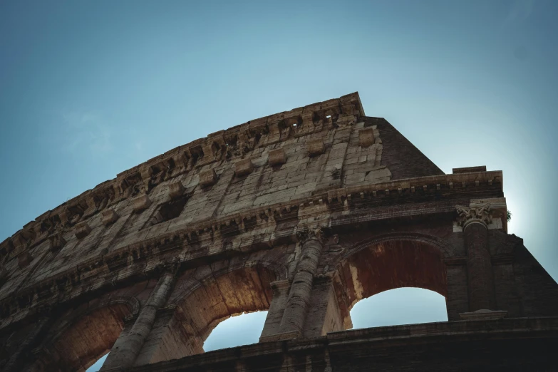 the sun shines through the arch of the colossion, by Daniel Lieske, pexels contest winner, neoclassicism, colosseum, promo image, view from the ground, 8 0 mm photo