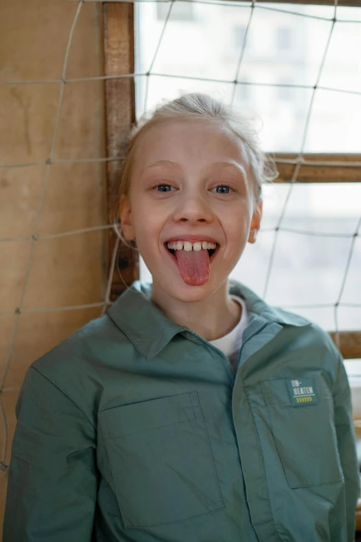 a young girl sticking out her tongue at the camera, albino white pale skin, greta thunberg, zoo, very excited