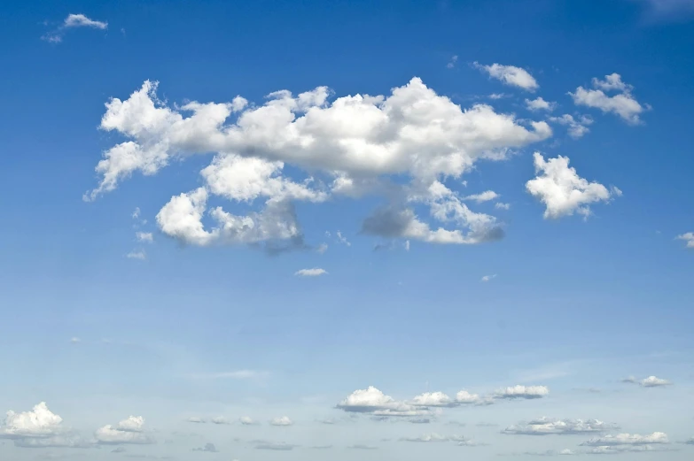 a man flying a kite on top of a lush green field, unsplash, minimalism, giant cumulonimbus cloud, light blues, where a large, istock