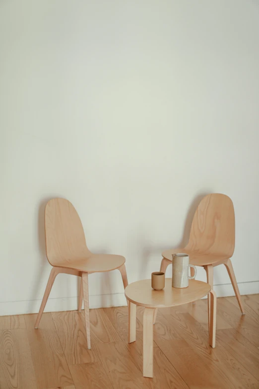 two chairs and a table in a room, inspired by Constantin Hansen, unsplash, conceptual art, plain background, dwell, product display photograph, tea