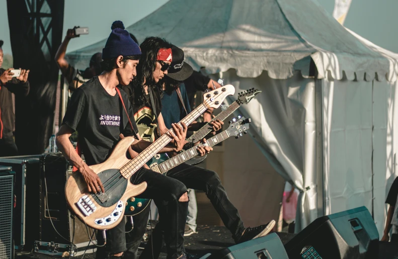 a group of young men sitting on top of a stage, pexels contest winner, antipodeans, bassist, japan grungerock from colors, profile image, desertpunk