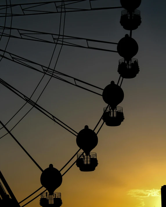 a ferris wheel is silhouetted against the setting sun, pexels contest winner, aestheticism, black silhouette, #trending, low quality photo, multiple stories