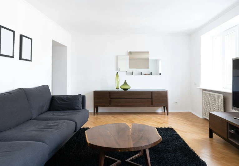 a living room filled with furniture and a flat screen tv, inspired by Constantin Hansen, pexels contest winner, minimalism, wooden coffee table, modern minimalist f 2 0 clean, third-person view, high details photo