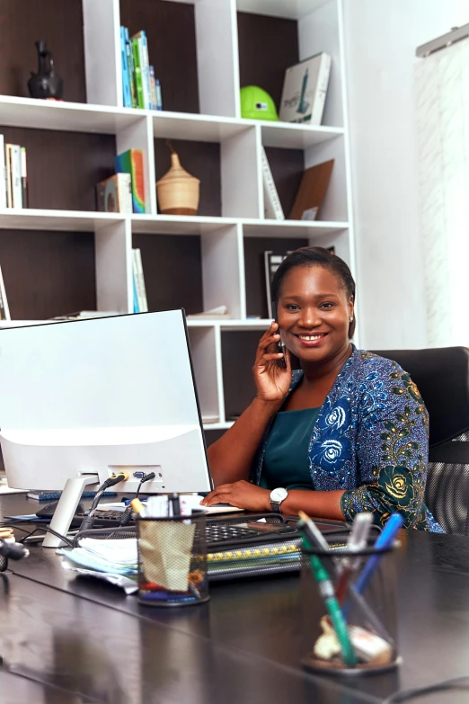 a woman sitting at a desk talking on a cell phone, by Chinwe Chukwuogo-Roy, pexels contest winner, female in office dress, big smirk, programming, decorative