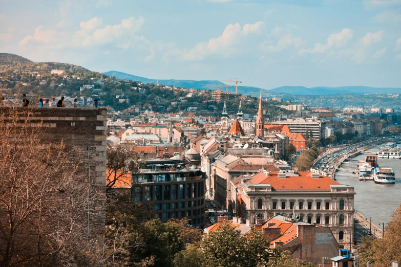 a view of a city from the top of a hill, by Emma Andijewska, pexels contest winner, renaissance, square, sunny day time, brown, full width