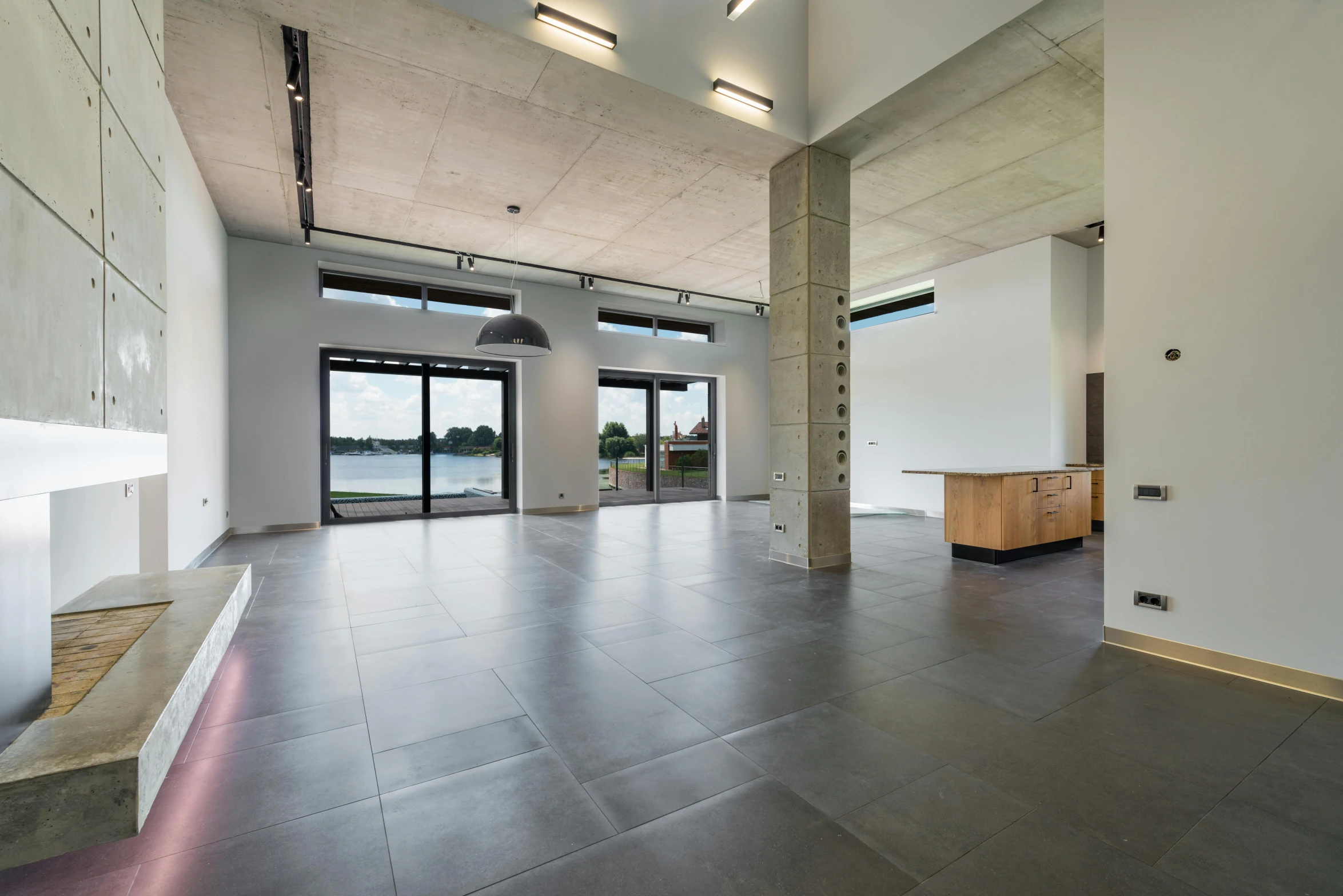 a living room filled with furniture and large windows, by Jan Tengnagel, bauhaus, tile floor, lake house, real estate photography, no - text no - logo