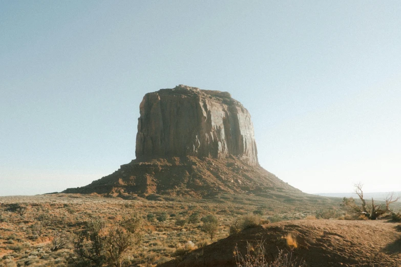 a large rock in the middle of a desert, unsplash contest winner, monumental structures, slightly tanned, sunfaded, hasselblad