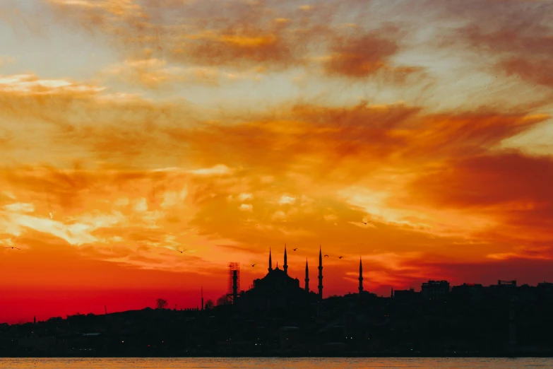 a large body of water with a building in the background, pexels contest winner, hurufiyya, sunset red and orange, ottoman sultan, youtube thumbnail, tie-dye