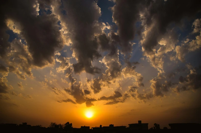 the sun is setting behind the clouds in the sky, by Ahmed Yacoubi, pexels contest winner, romanticism, iraq nadar, sky is orangish outside, skybox, low - angle