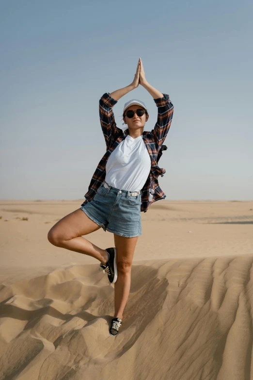 a woman doing a yoga pose in the desert, pexels contest winner, doing a sassy pose, 🚿🗝📝, arabian features, casually dressed