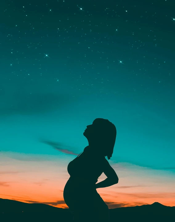 a woman standing on top of a hill under a sky full of stars, an album cover, pexels contest winner, pregnant belly, ((sunset)), teal aesthetic, background image