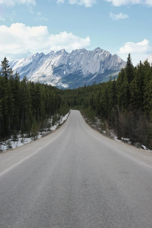 an empty road with mountains in the background, by Brigette Barrager, banff national park, single, cut, front facing