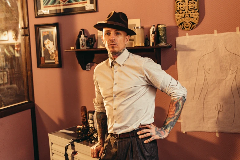 a man that is standing up with his hands on his hips, a portrait, by Lee Loughridge, pexels, bauhaus, tattoo parlor photo, caracter with brown hat, wearing a shirt with a tie, thumbnail