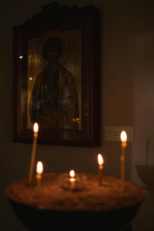 candles are lit in front of a painting, inspired by Cimabue, shot on sony a 7 iii, icon, brown, gallery