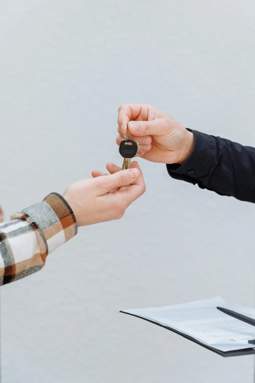 a man handing a car key to a woman, pexels contest winner, modernism, square, airbnb, on a gray background, small