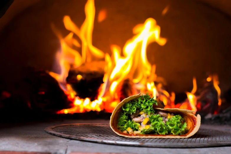 a burrito sitting on a plate in front of a fire, renaissance, vibrant atmosphere, profile image, tacos, multiple stories