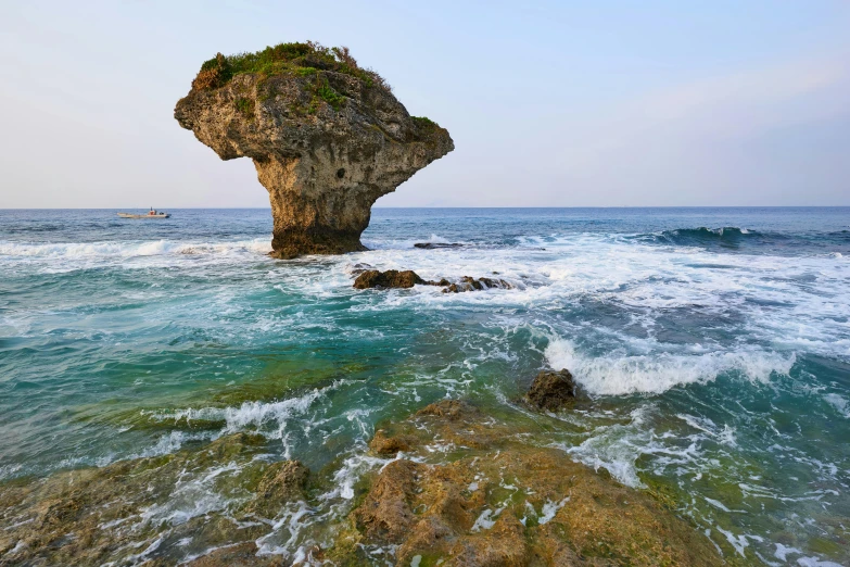 a rock formation in the middle of the ocean, inspired by Kōno Michisei, sumatraism, perched on a rock, okinawa japan, square, slide show